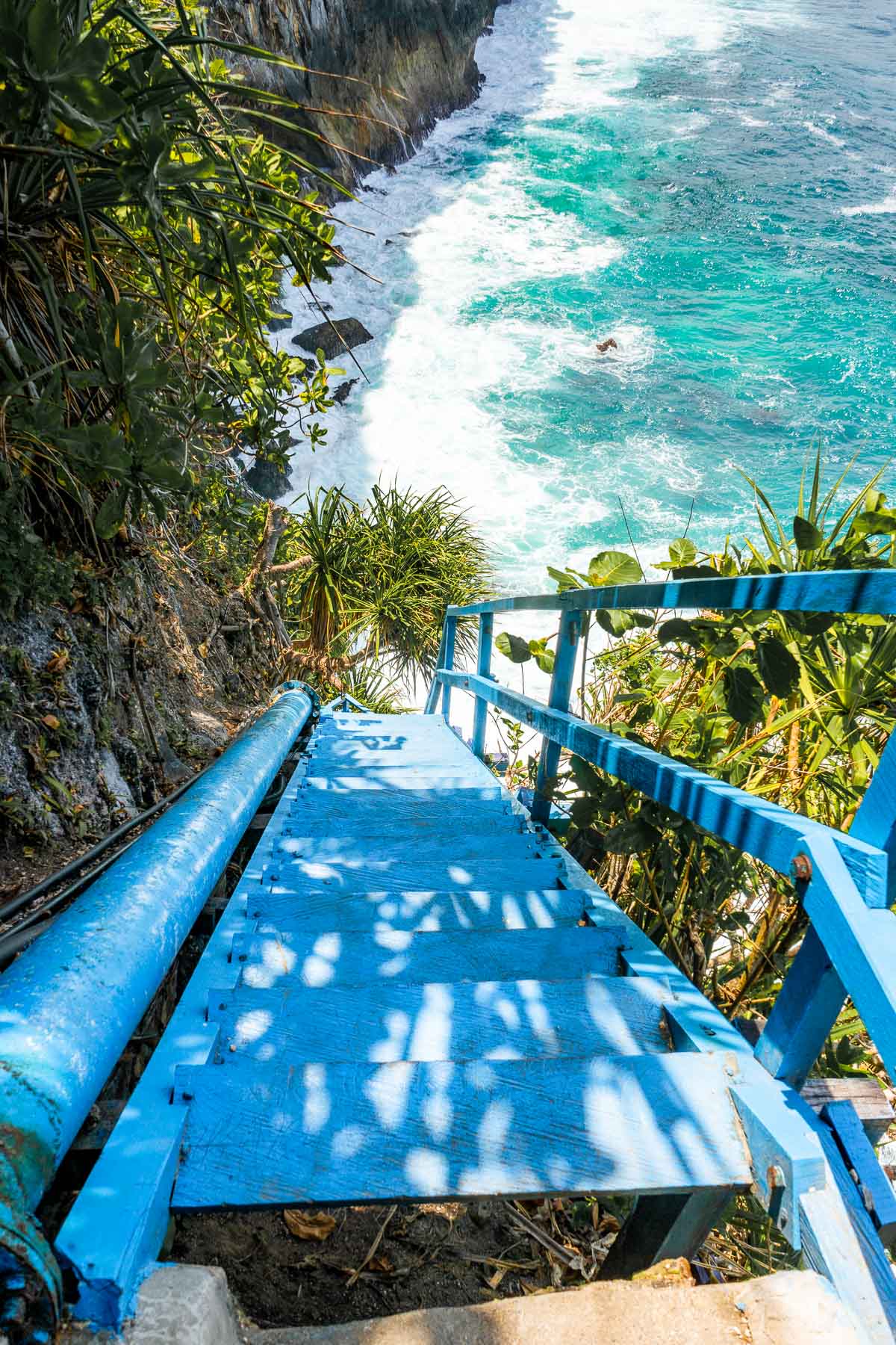 Blue stairway leading down to Peguyangan Waterfall, Nusa Penida