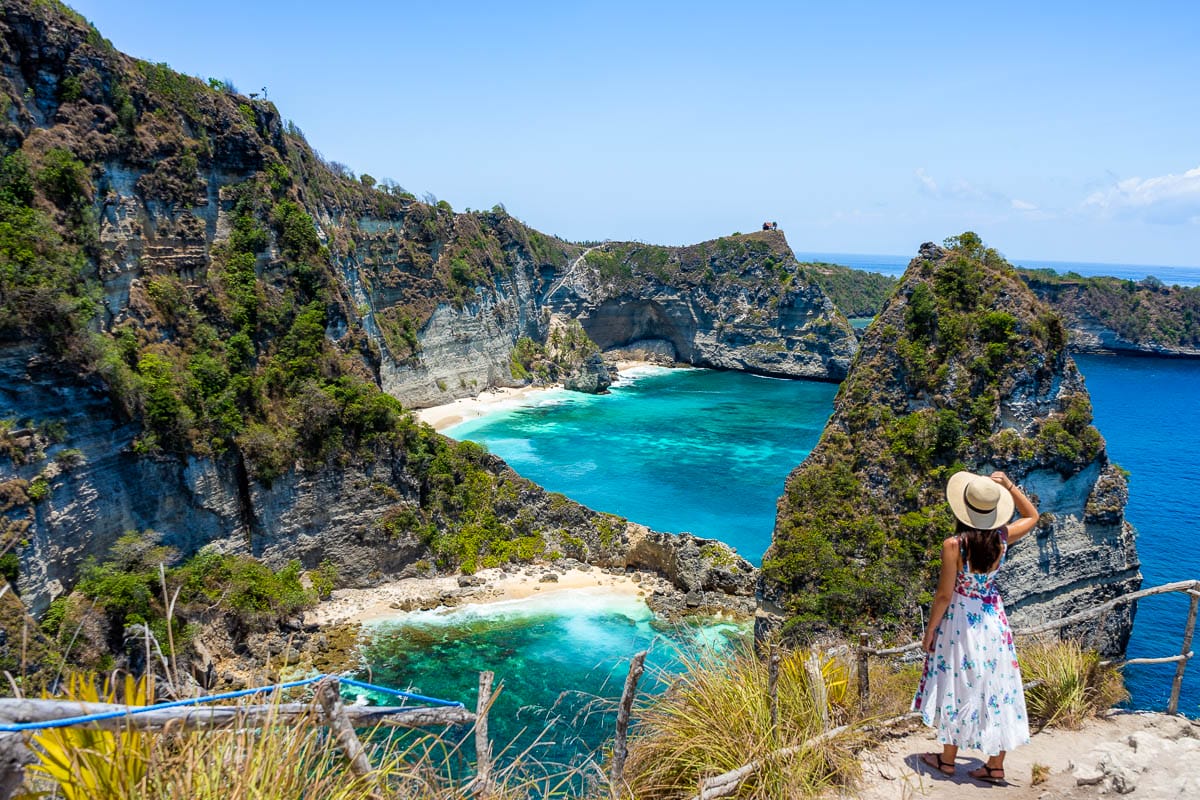 Girl in a white dress looking at the view at Thousand Islands Viewpoint on Nusa Penida