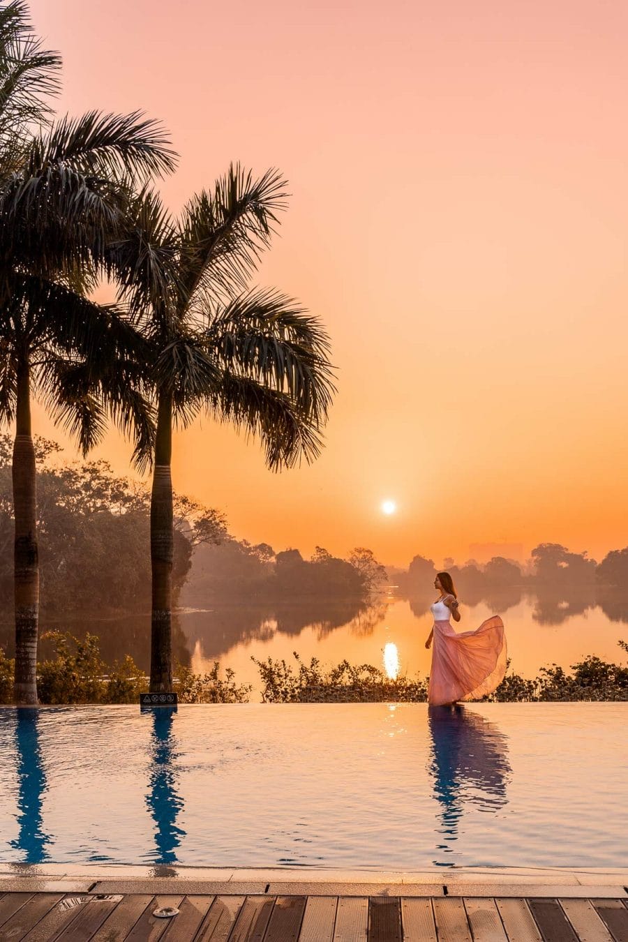 Girl at sunrise by the pool in Lotte Hotel Yangon