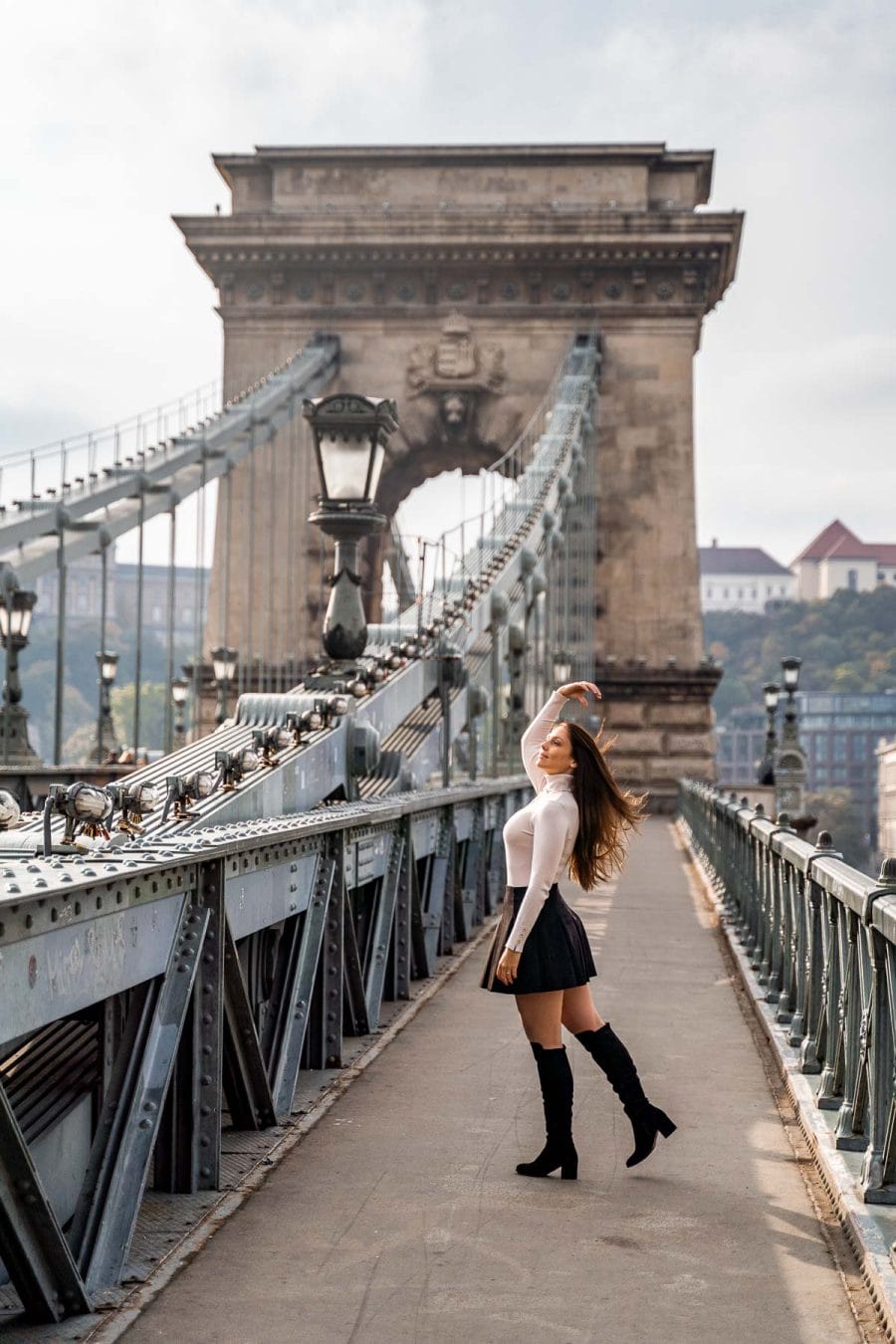 Girl standing on the Szechenyi Chain Bridge in Budapest