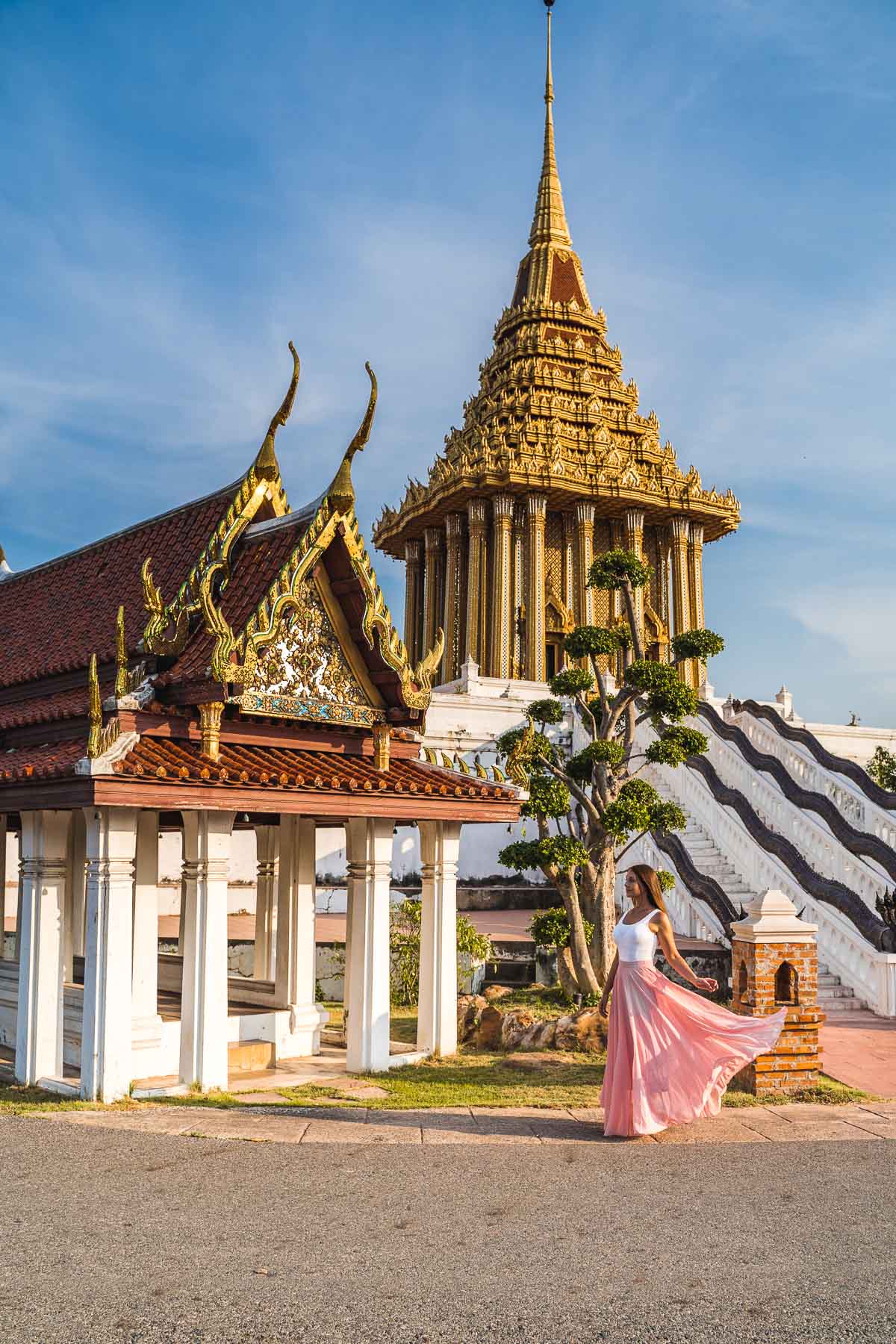 Girl in a pink dress standing in front of temples at the Ancient Siam Bangkok