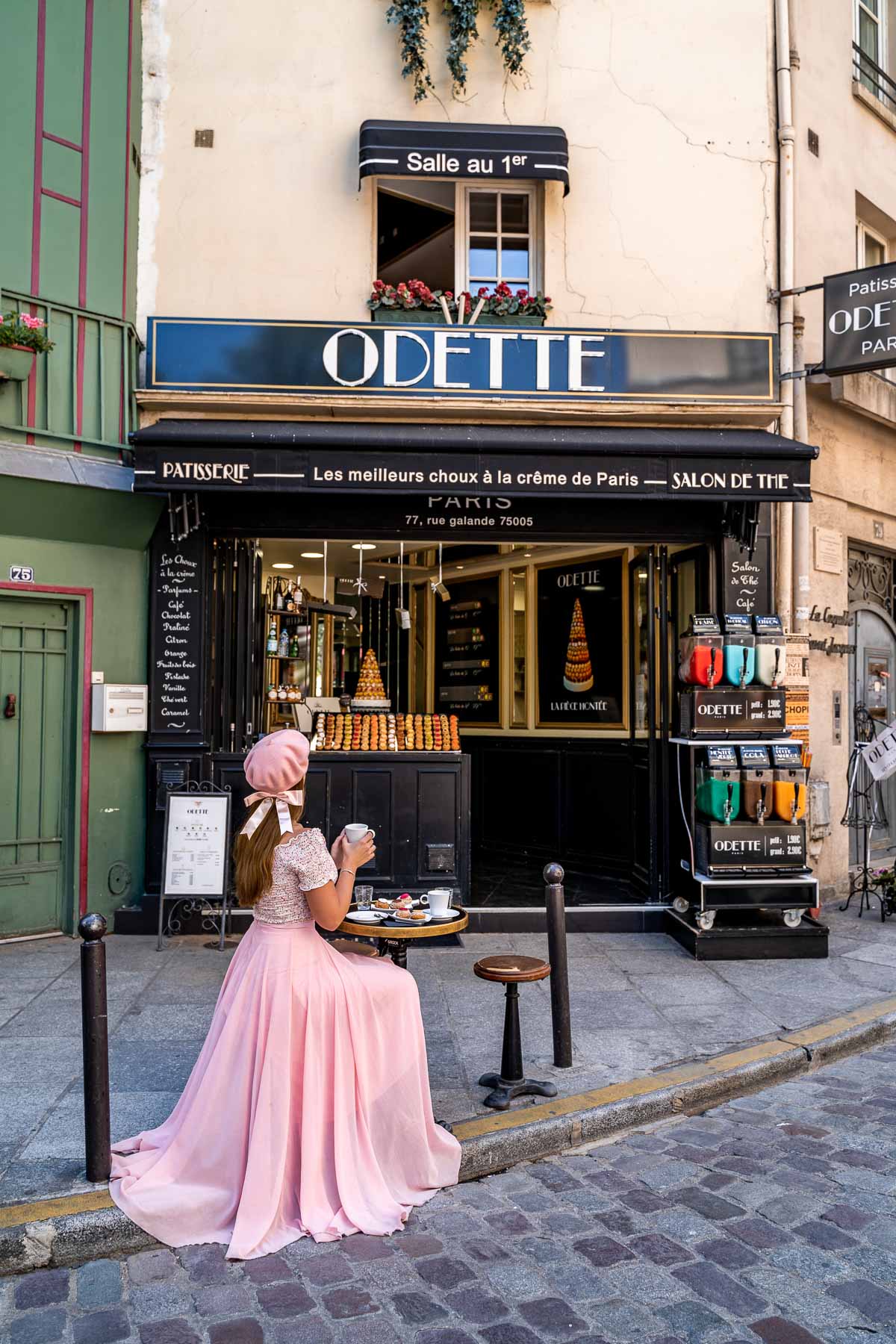 Girl in a pink dress sitting in front of Odette Paris