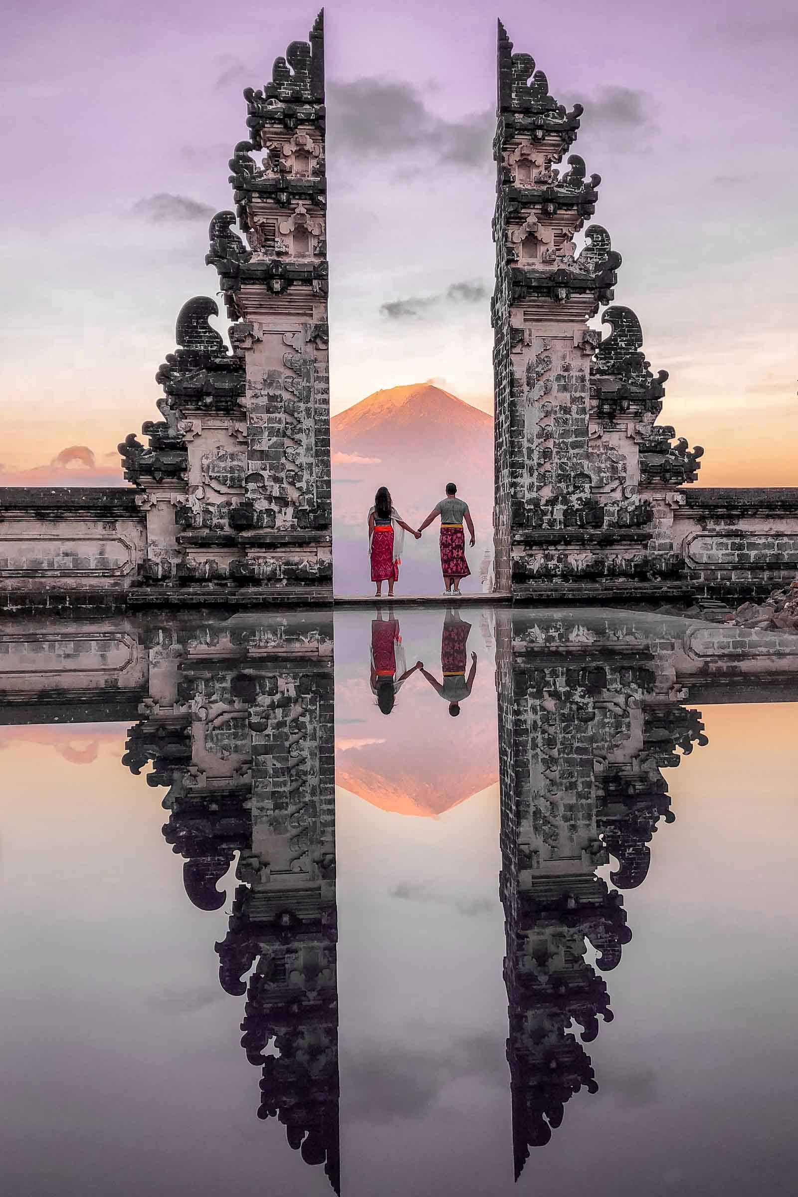Girl and a boy standing at the Gates of Heaven at Pura Lempuyang in Bali