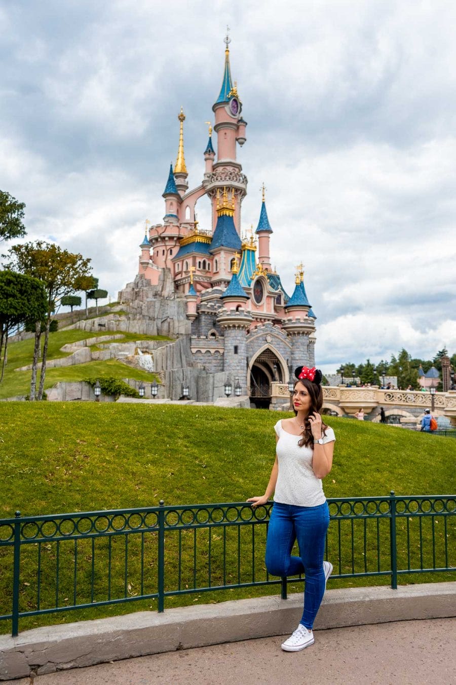 Girl standing in front of Sleeping Beauty's Castle in Disneyland Paris, which is one of the best Paris Instagram spots