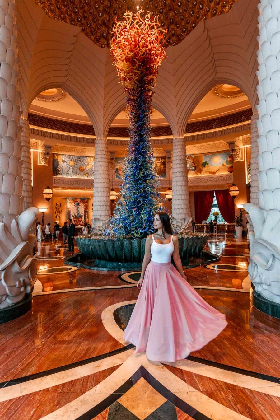 Girl in pink skirt standing in the lobby of the Atlantis hotel in Dubai