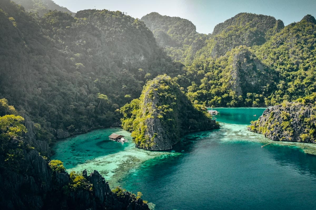 The view of the blue sea and the lush green mountains at Coron, Philippines