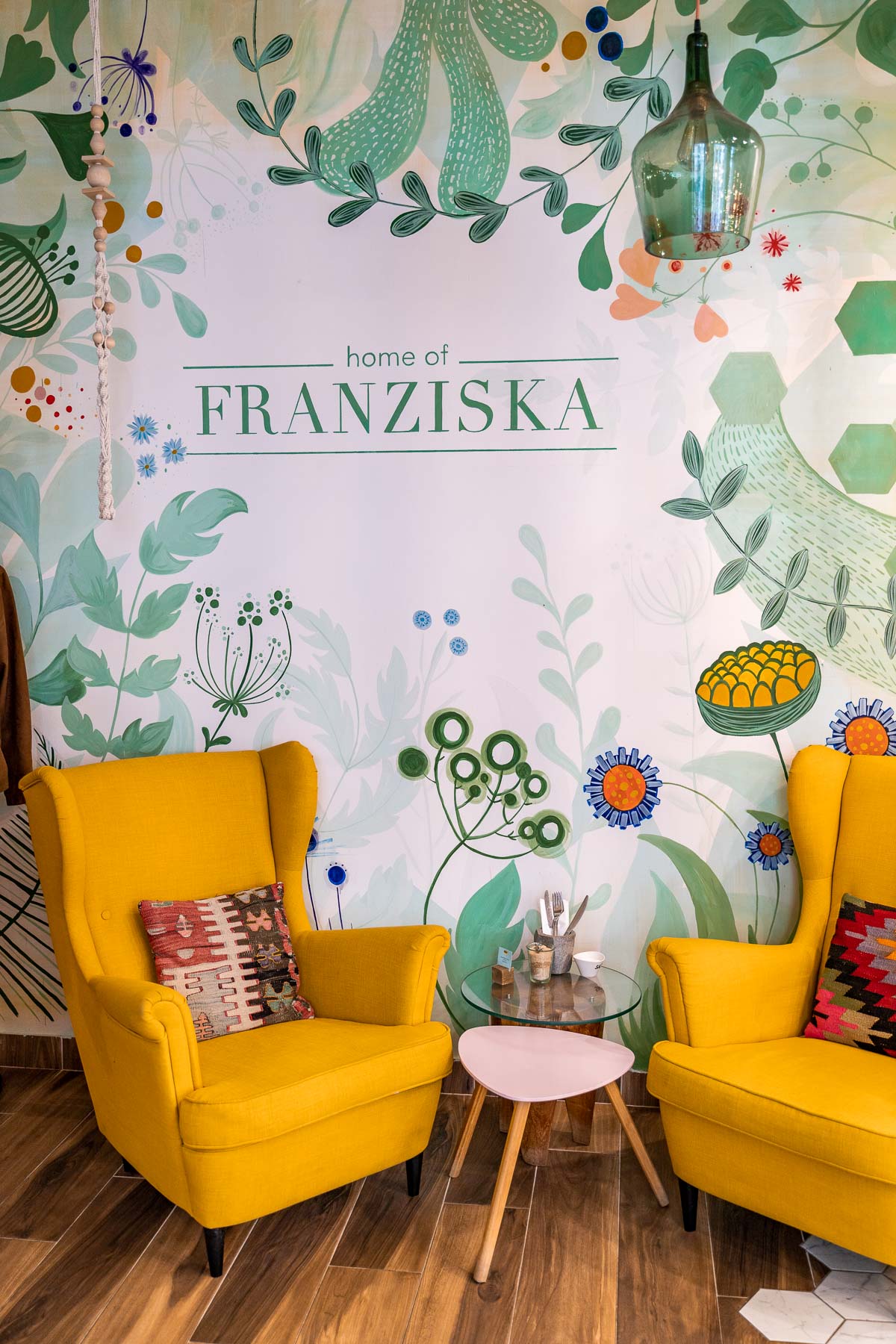 Interior with green walls and yellow armchairs at Home of Franziska in Budapest