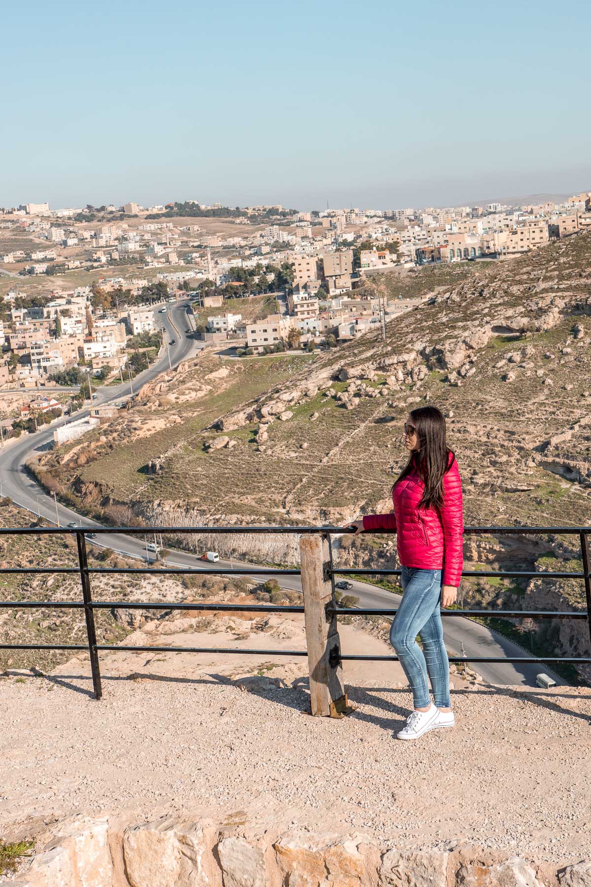 Girl in a pink jacket standing at the Kerak Castle in Jordan