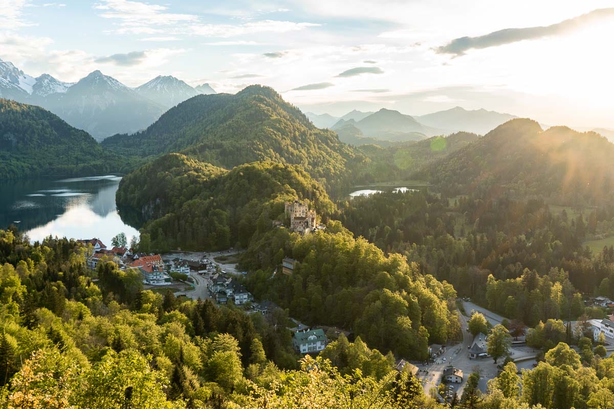 View of the Neuschwanstein Castle and the Hohenschwangau Castle from an upper viewpoint at sunset