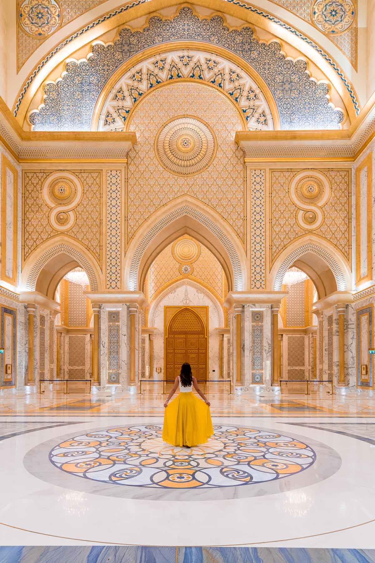 Girl in a yellow skirt standing in the middle of Qasr al Watan Palace, Abu Dhabi