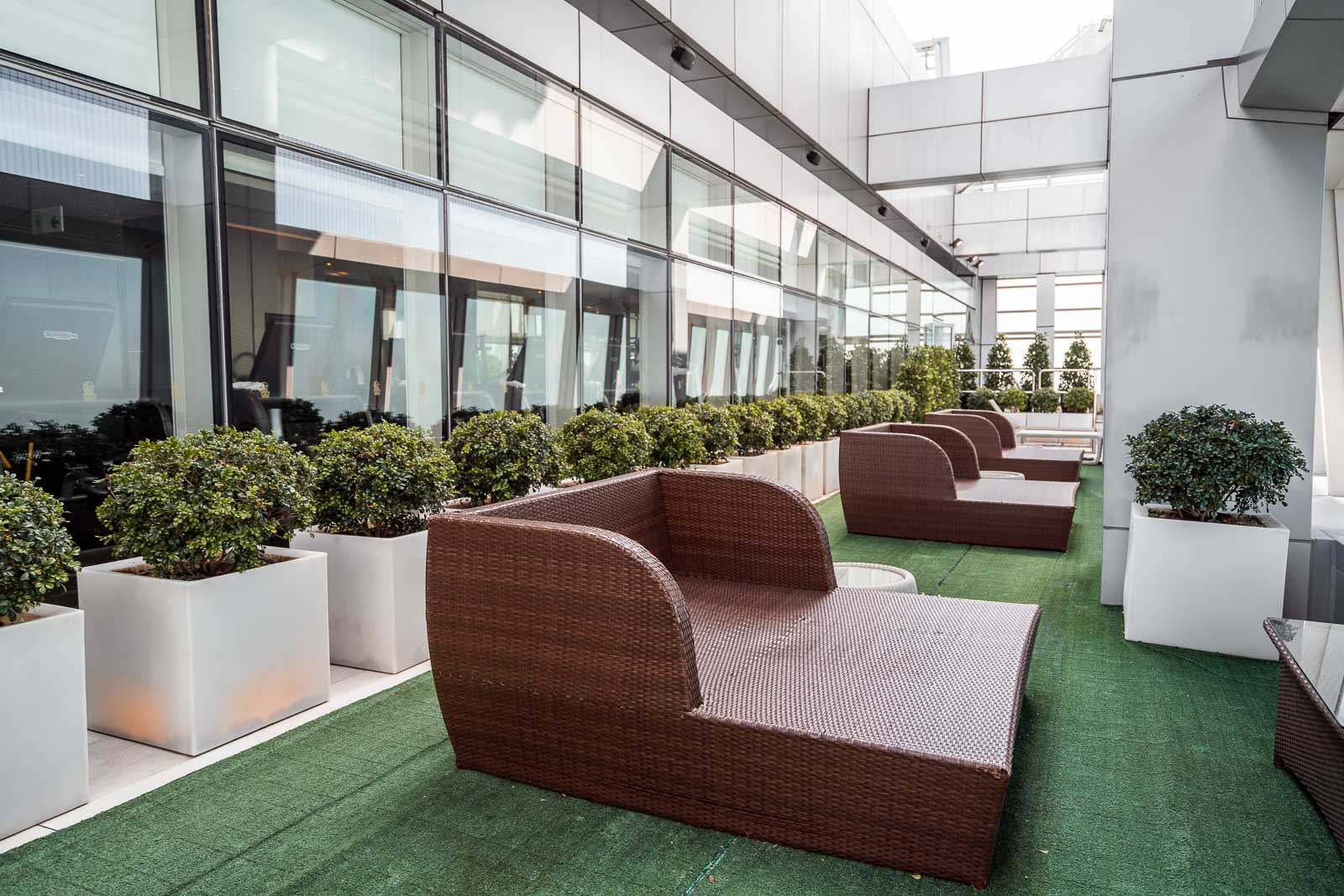 Outdoor terrace on the 118th floor with chairs and green plants