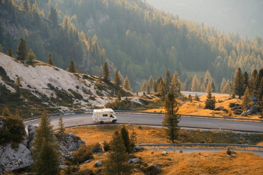 Van on a mountain road at sunset
