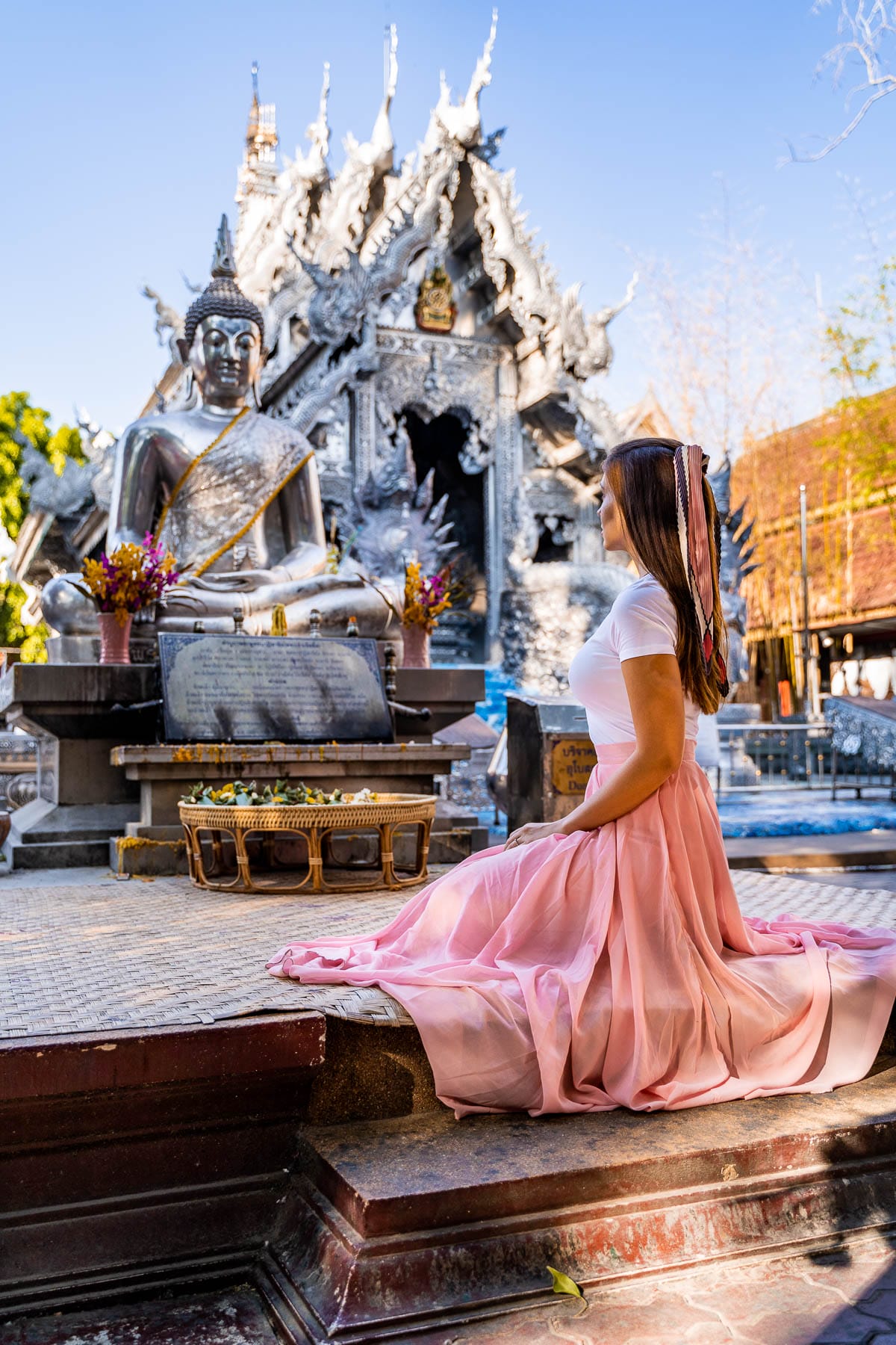 Wat Sri Suphan, the Silver Temple in Chiang Mai, Thailand with girl in a pink skirt in the middle