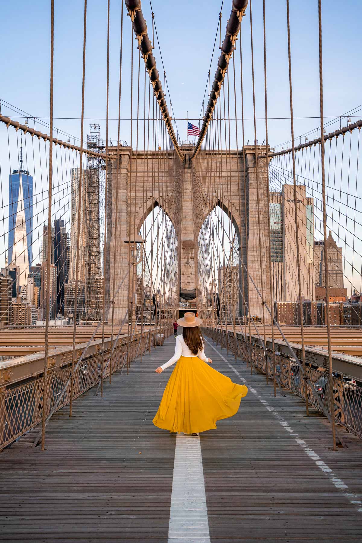 Girl in yellow skirt on Brooklyn Bridge in New York
