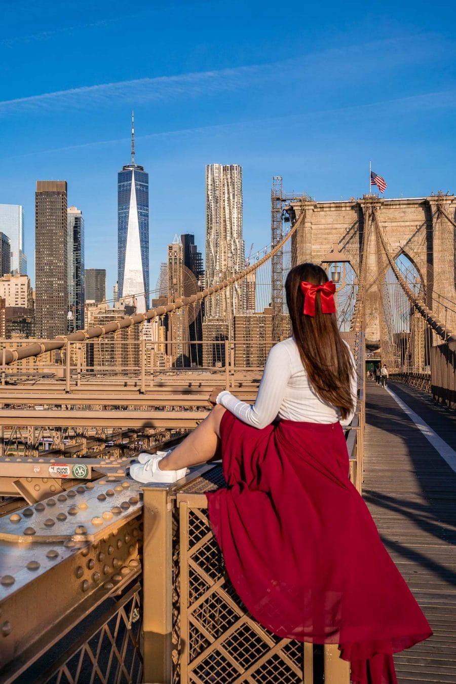 Girl in red skirt on Brooklyn Bridge in New York