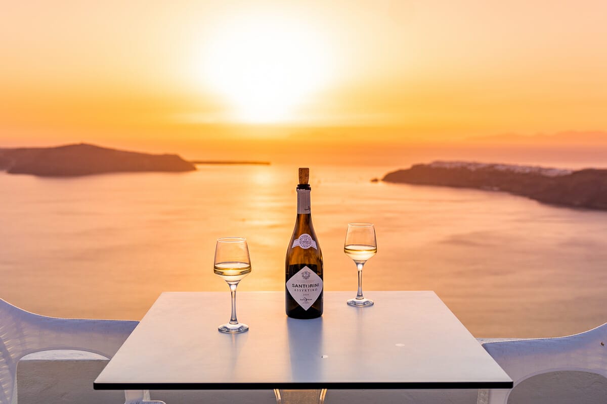 Wine glasses on the table at sunset at Kasimatis by La Perla, Imerovigli