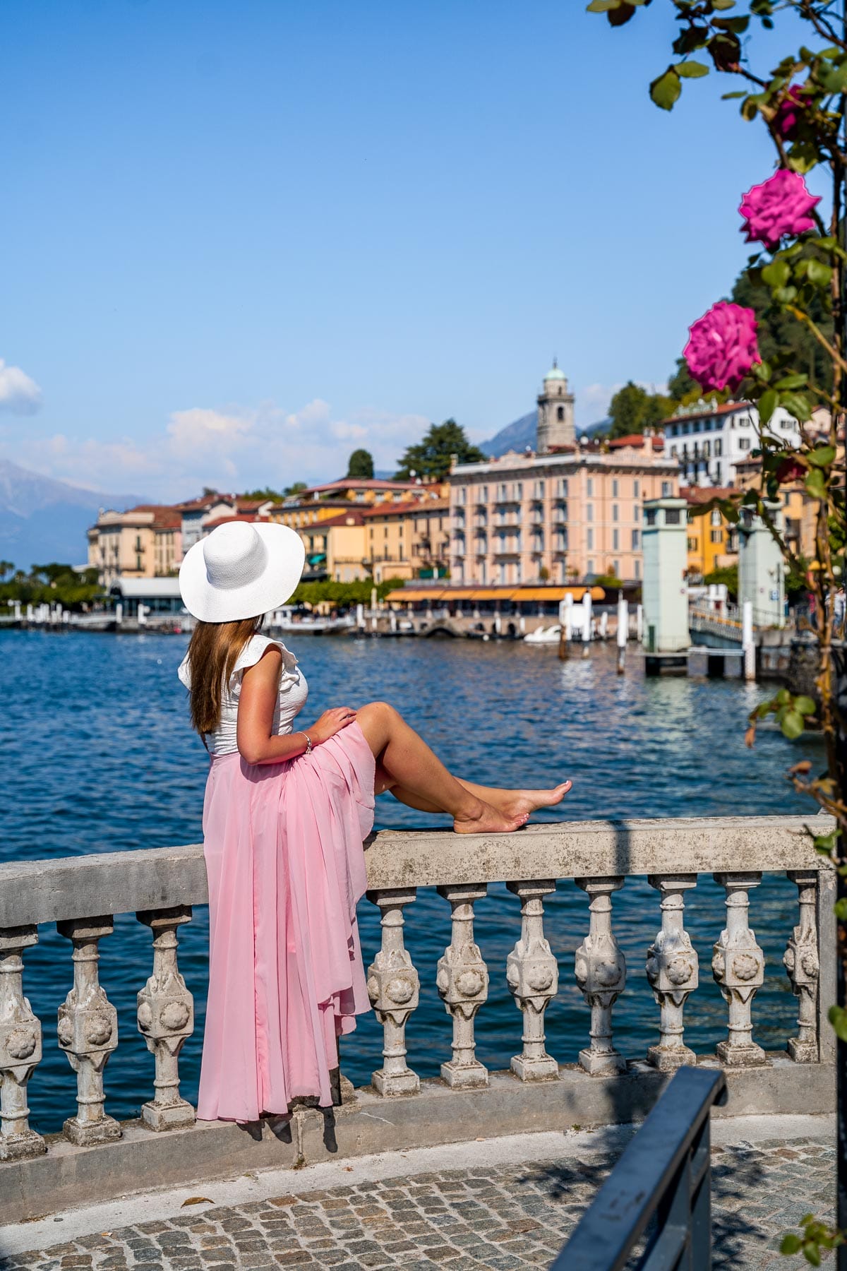 Girl in a pink skirt looking at the waterfront in Bellagio, Lake Como