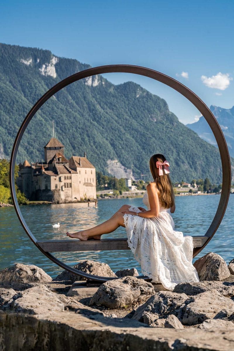 Girl in a white skirt in front of Chillon Castle, Switzerland