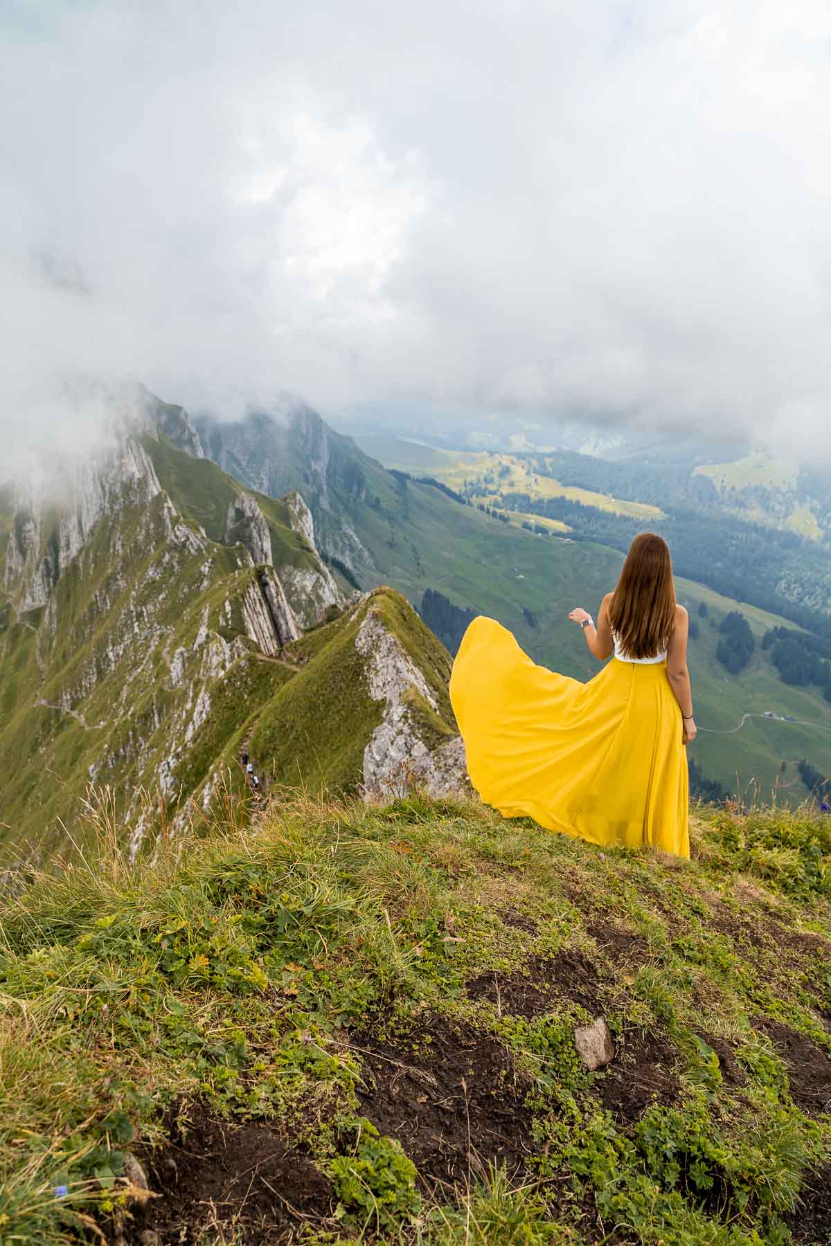 Girl in a yellow skirt in front of Schaeffler Ridge, Ebenalp, Switzerland