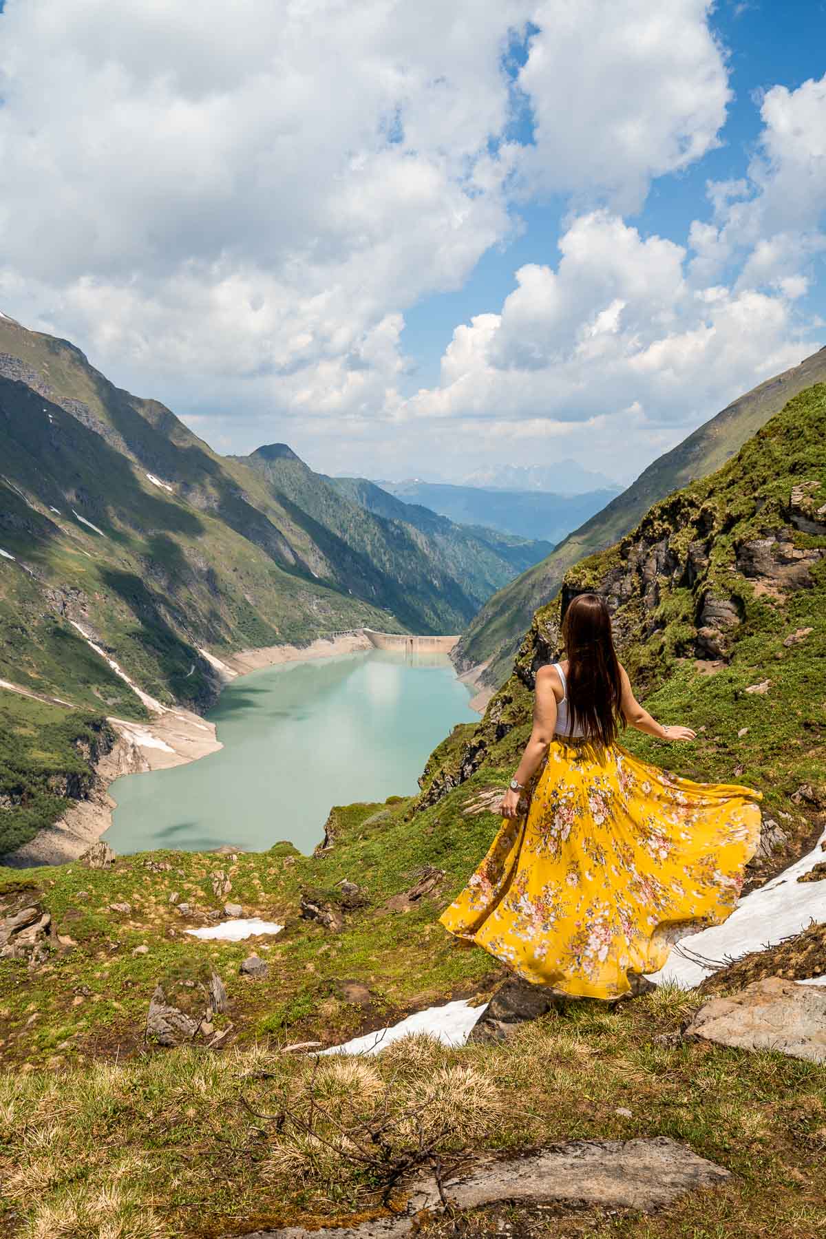 Girl in a yellow dress in front of Stausee Mooserboden, Austria