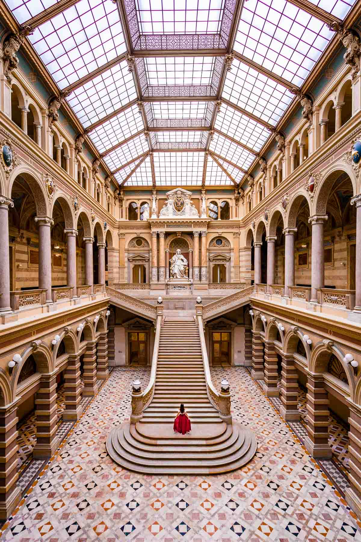 Girl in a red skirt inside the Palace of Justice, one of the best Vienna Instagram spots