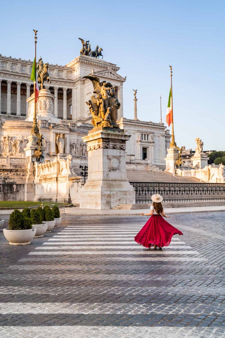 Girl in a red skirt in front of Altare della Patria in Rome, Italy