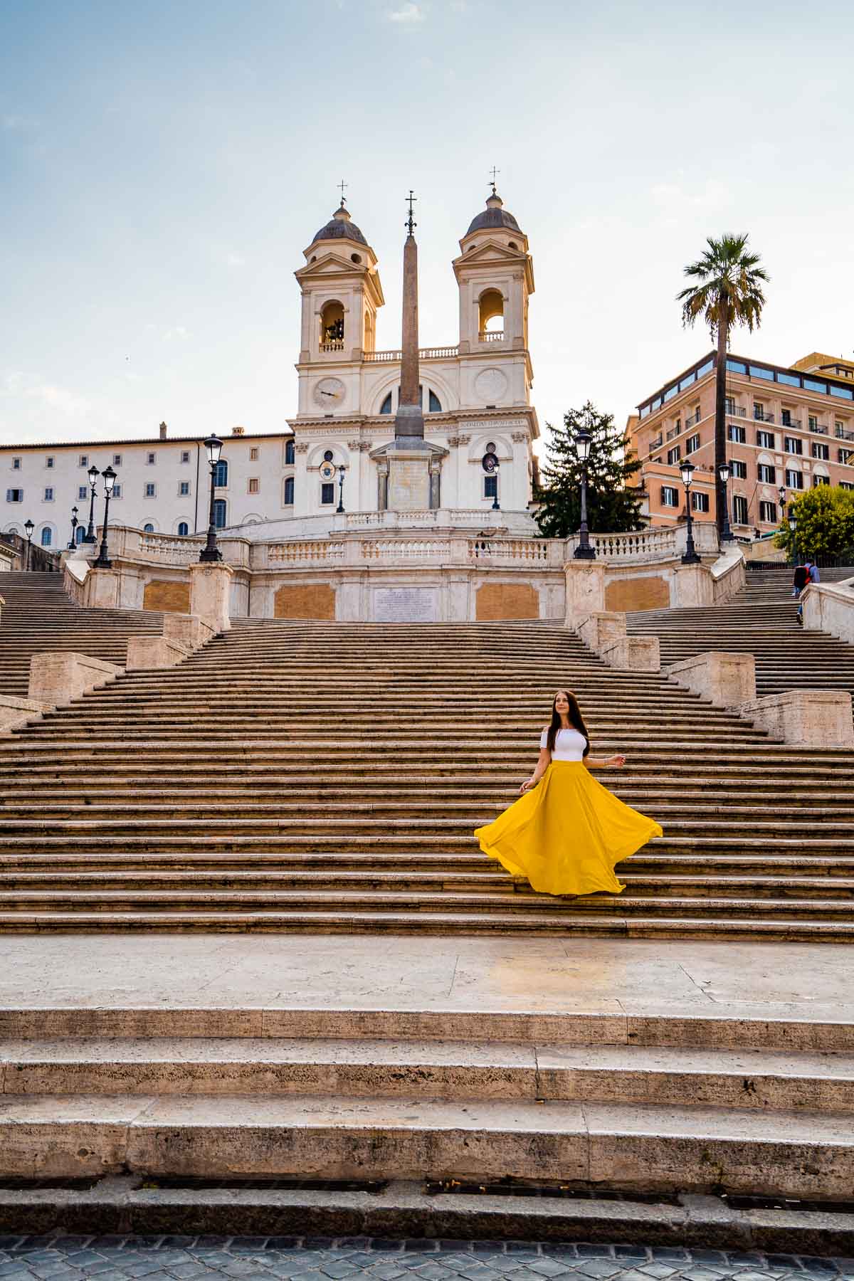 Girl in a yellow skirt on the Spanish Steps, which is one of the best Rome Instagram spots