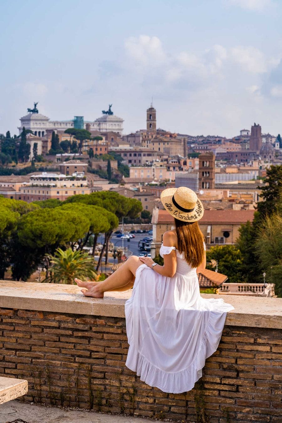Girl in a white dress watching the view from Giardino degli Aranci, Rome