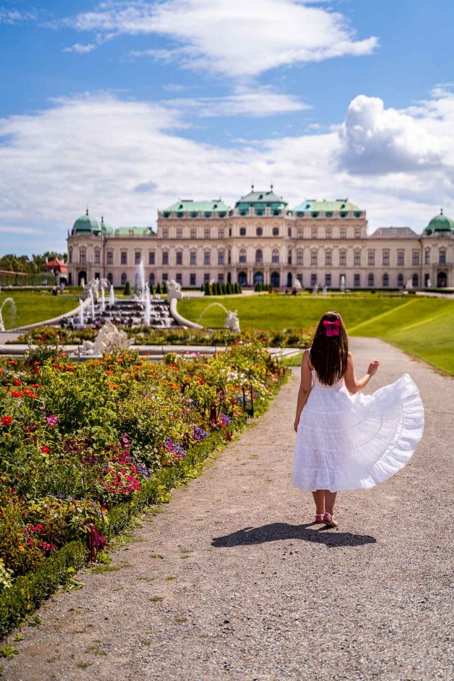 Girl in a white dress in the garden at Belvedere Palace in Vienna