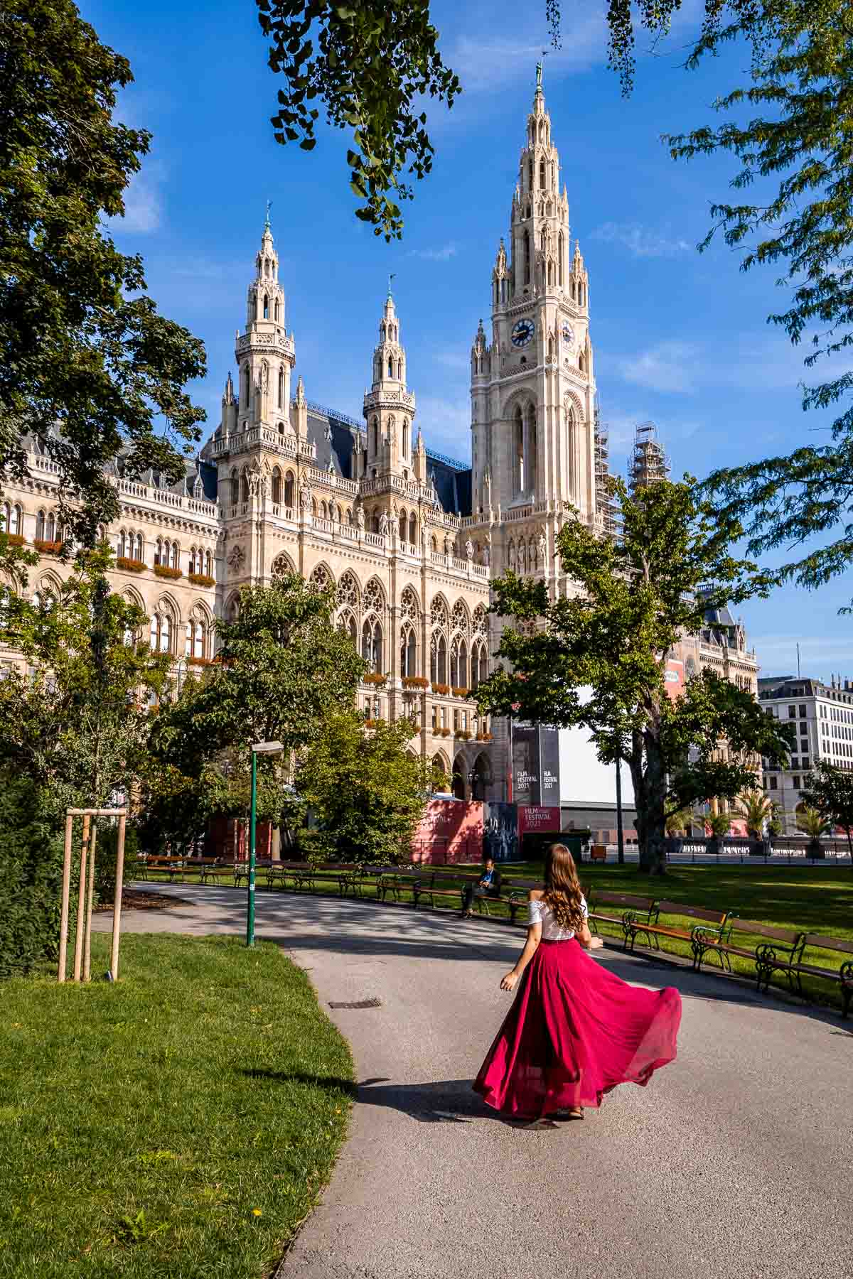 Girl in a red skirt in front of Rathaus in Vienna, Austria