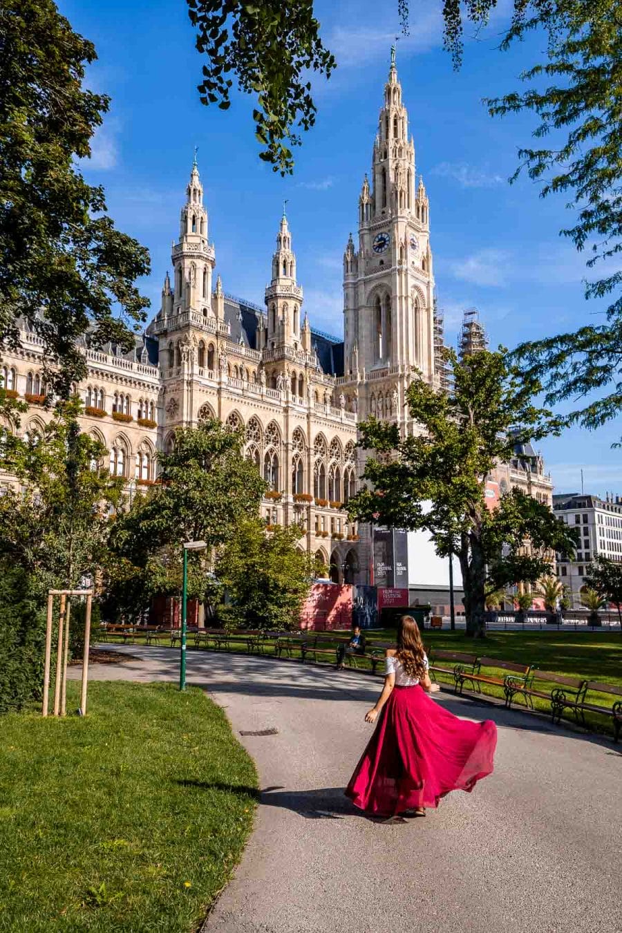 Girl in a red skirt in front of Rathaus in Vienna, Austria