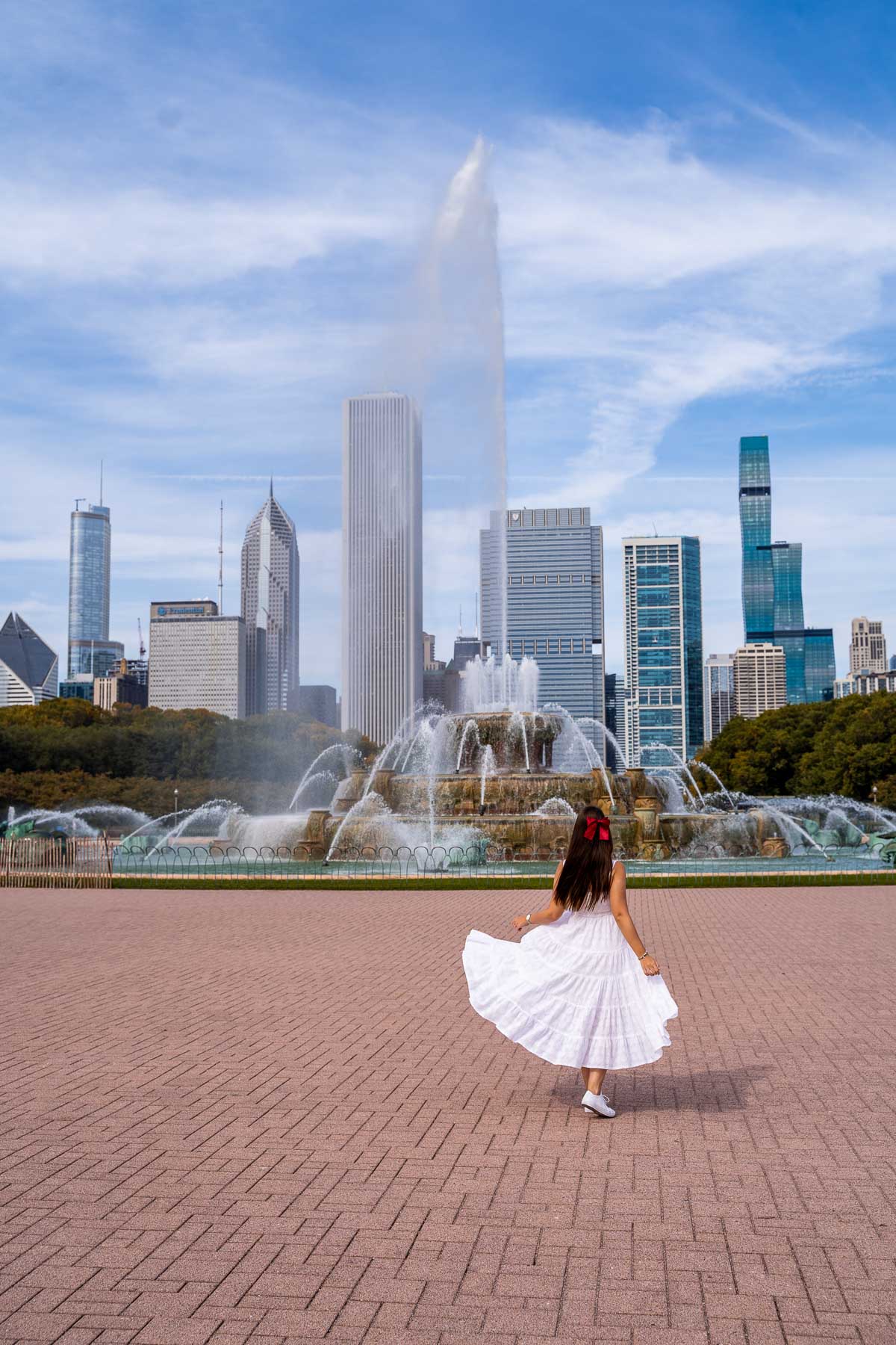 Girl in white dress in front of the Buckingham Fountain in Chicago