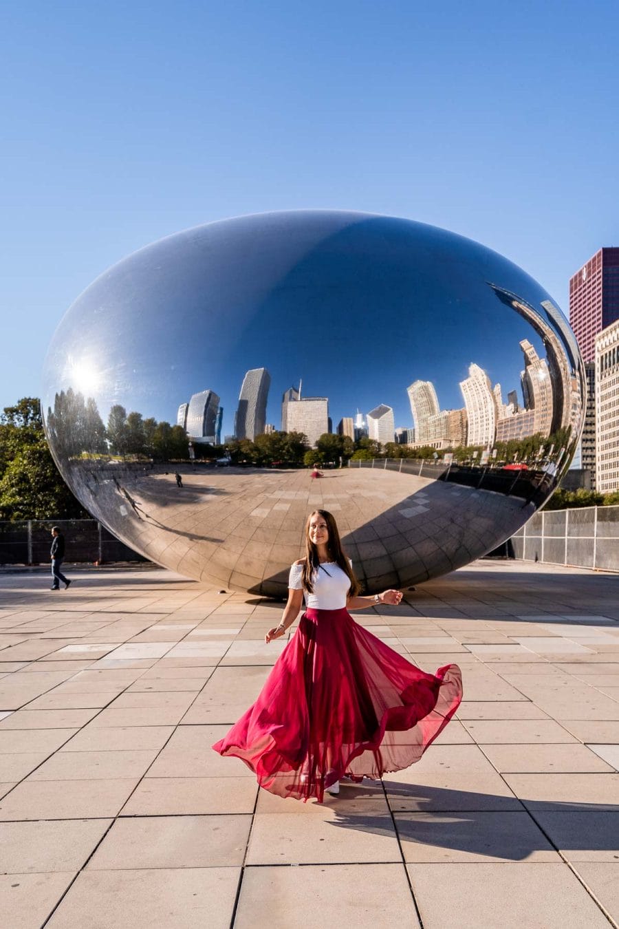 Girl in red skirt in front of the Chicago Bean, a must see Instagrammable place in Chicago
