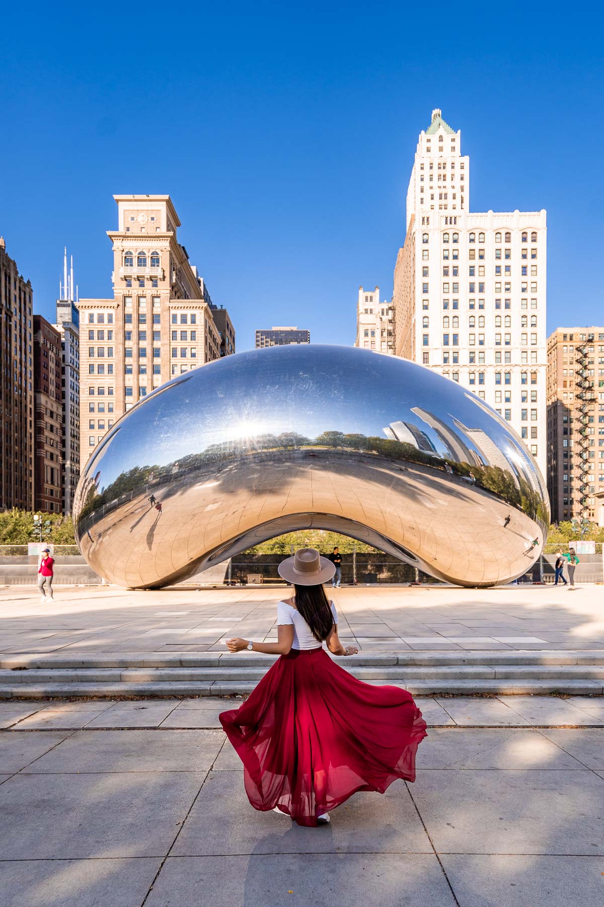 Girl in red skirt in front of the Chicago Bean, one of the best Instagram spots in Chicago