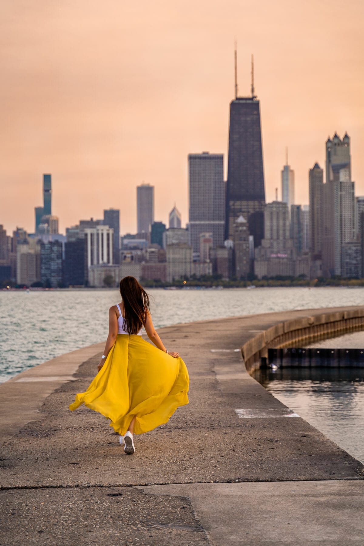 Girl in yellow skirt running at the North Avenue Beach in Chicago