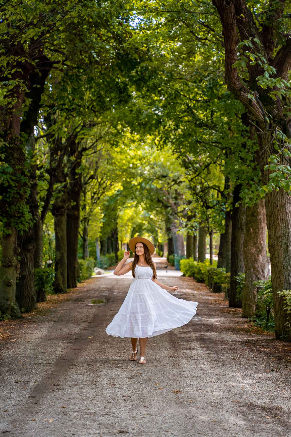 Girl in a white dress under a Tree tunnel at Schönbrunn Palace, Vienna