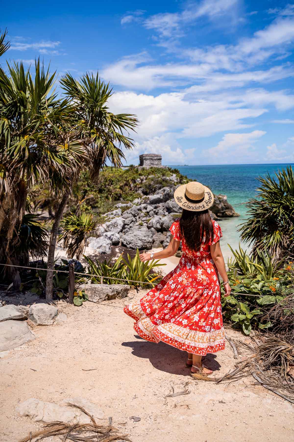 Girl in a red dress at Tulum ruins