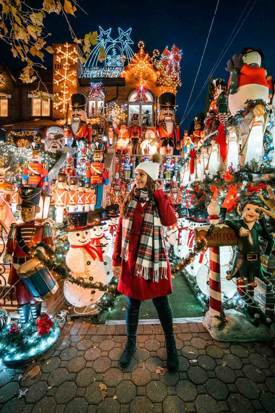 Girl in red coat visiting Dyker Heights Christmas Lights