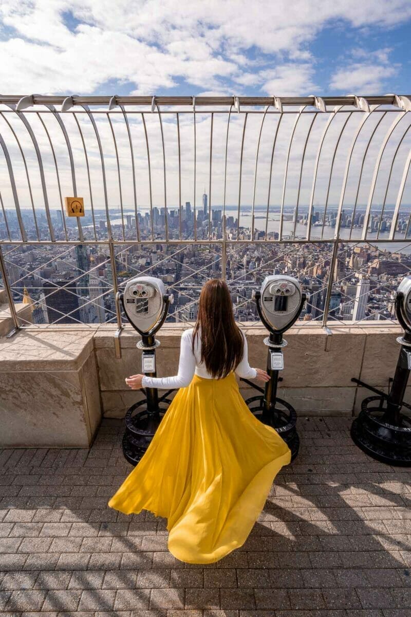 Girl in yellow skirt at the Empire State Building in New York