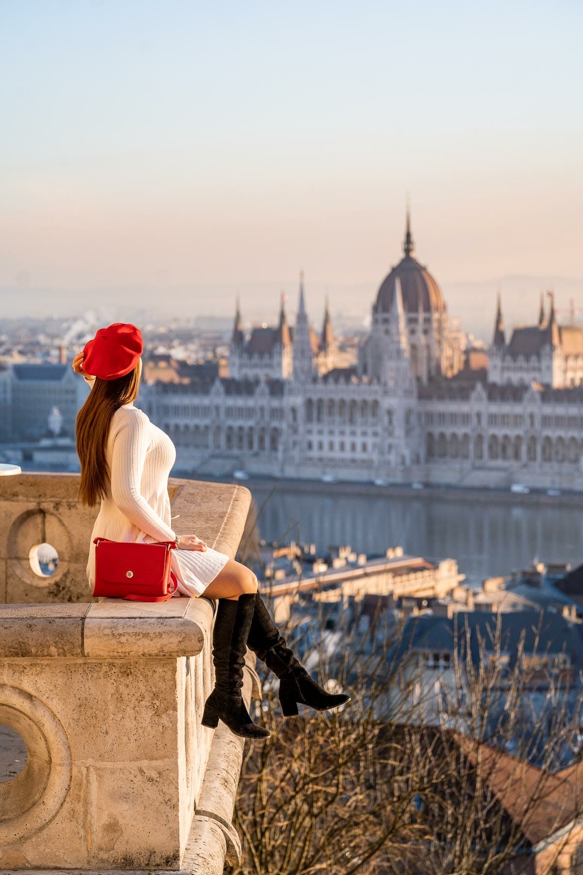 Girl sitting at the Fisherman's Bastion in Budapest in winter