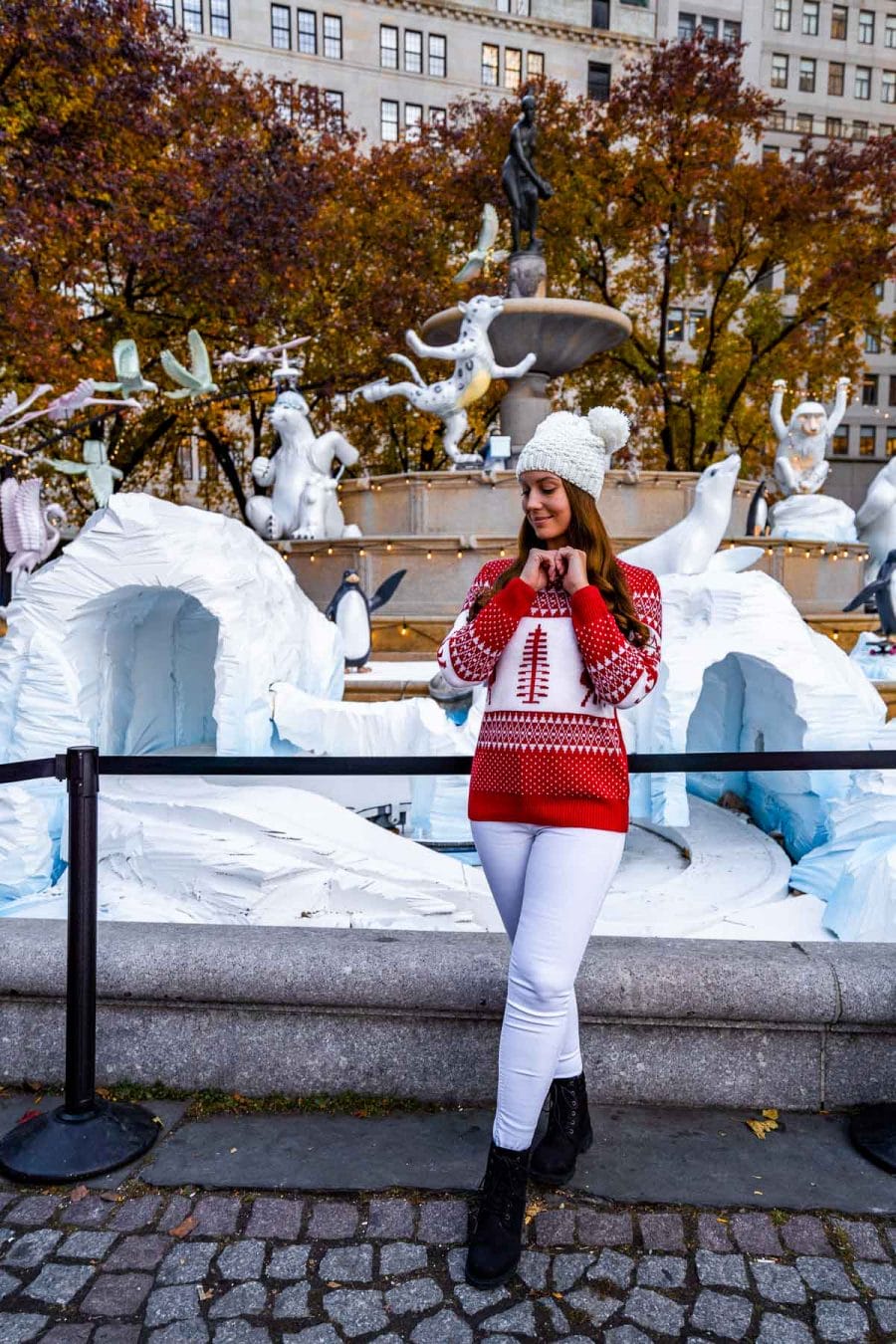 Girl in Christmas sweater in front of Pulitzer Fountain with Christmas decoration