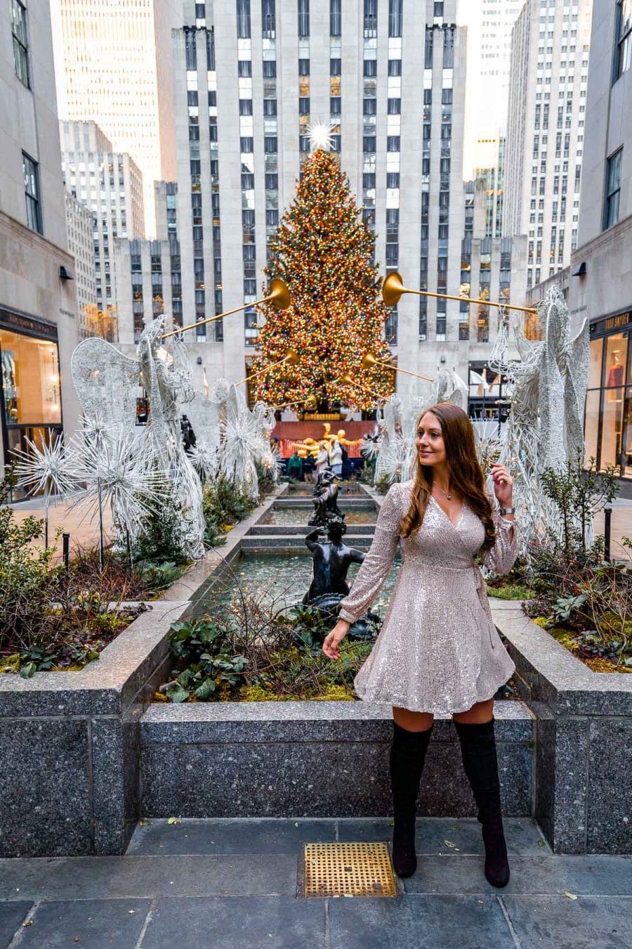 Girl standing in front of the Christmas tree at Rockefeller Center
