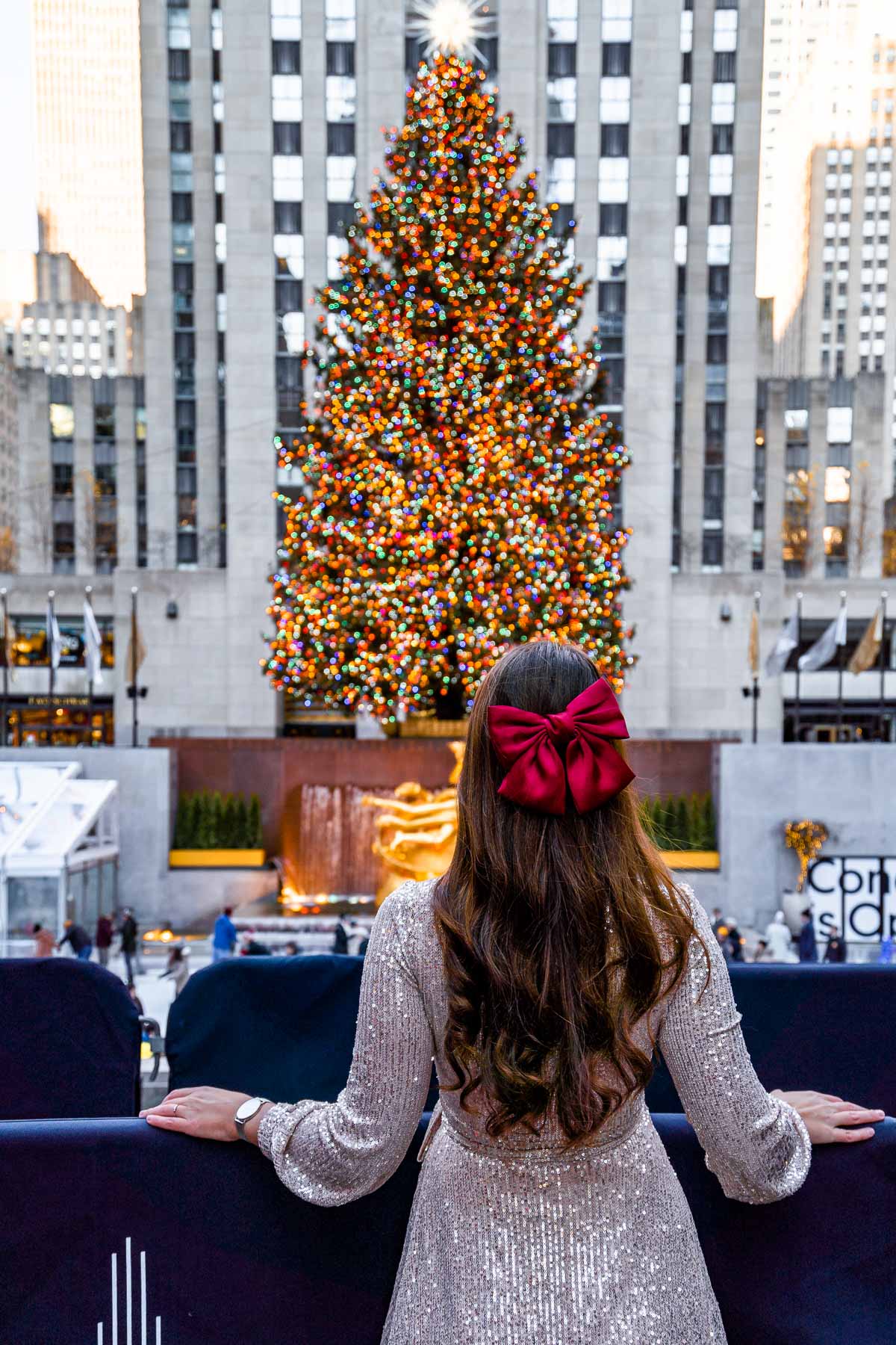 Girl standing in front of the Christmas tree at Rockefeller Center