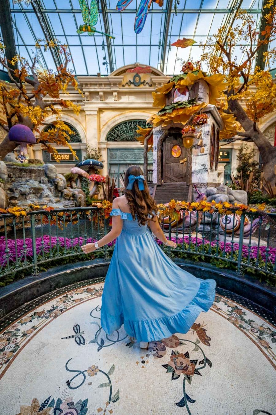Girl in blue dress at the Bellagio Conservatory & Botanical Gardens, one of the most Instagrammable places in Las Vegas