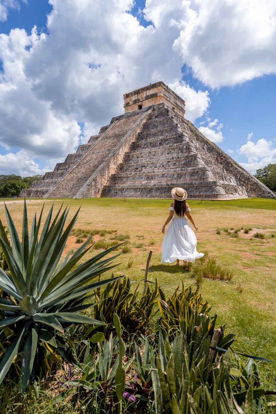 Girl in white dress in front of the El Castillo Pyramid at Chichen Itza