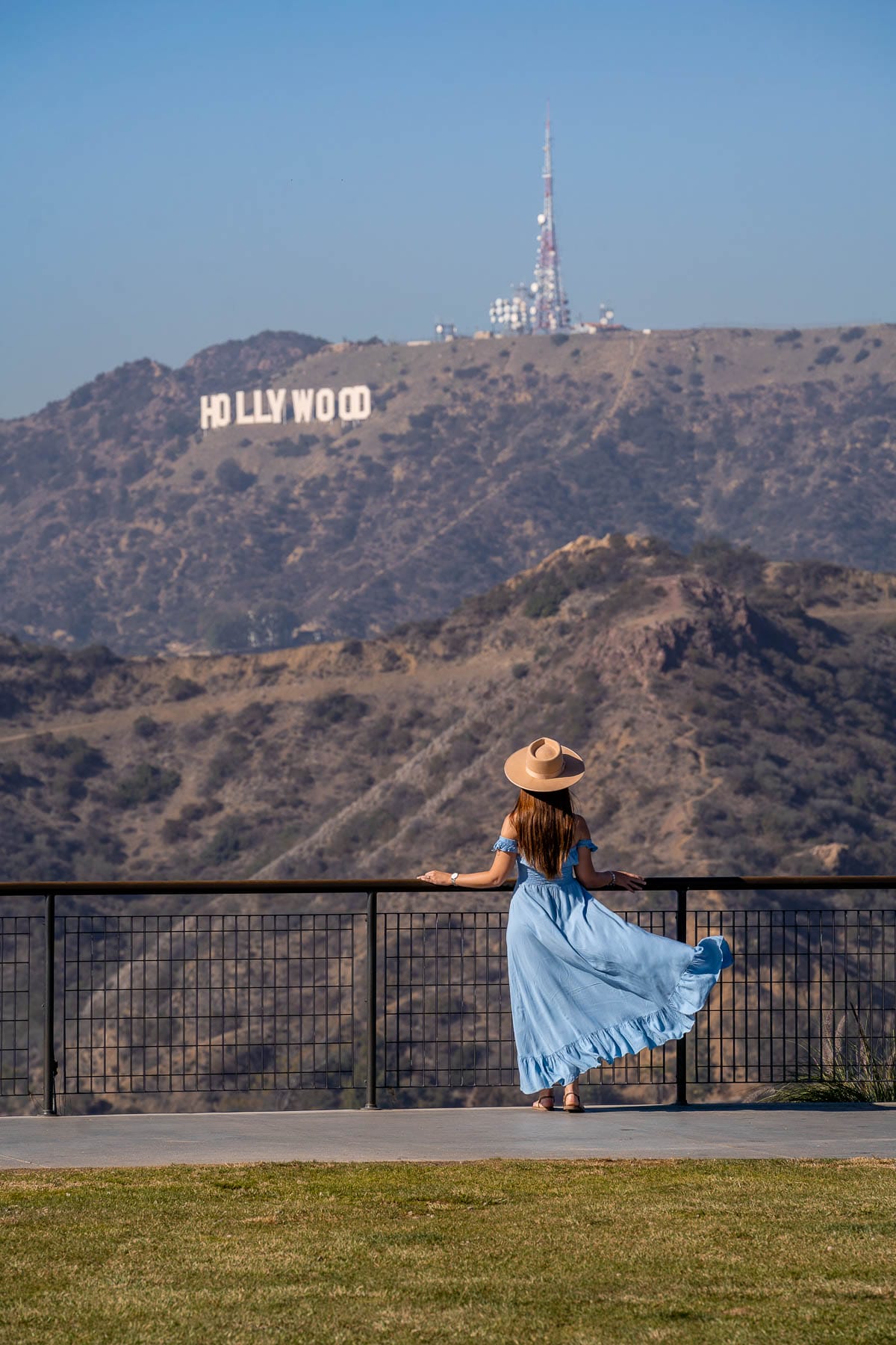 Girl in blue dress looking at the Hollywood Sign from Griffith Observatory