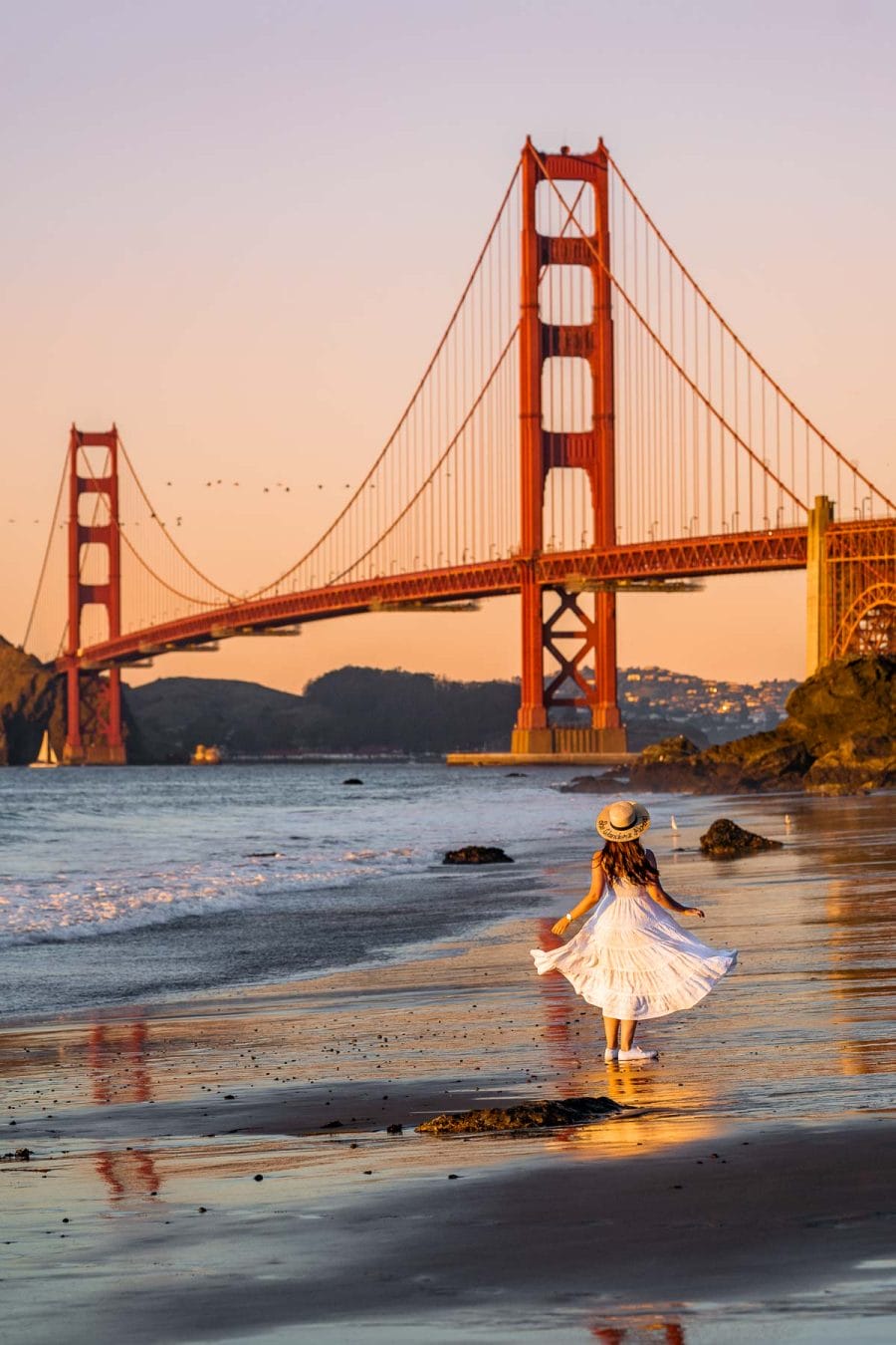 Girl in white dress at Marshall’s Beach in San Francisco at sunset