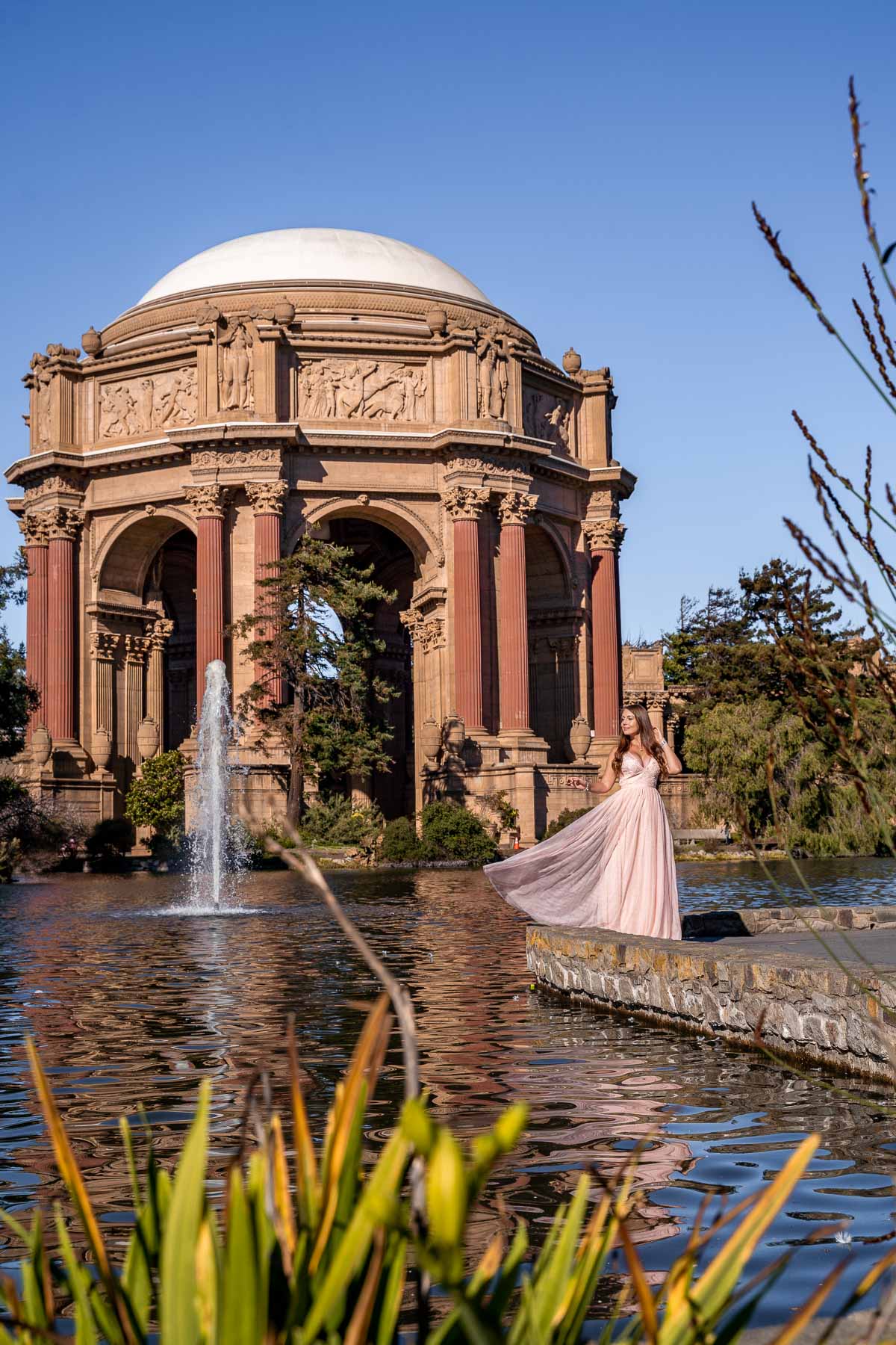 Girl in pink dress in front of the Palace of Fine Arts, one of the best San Francisco Instagram spots