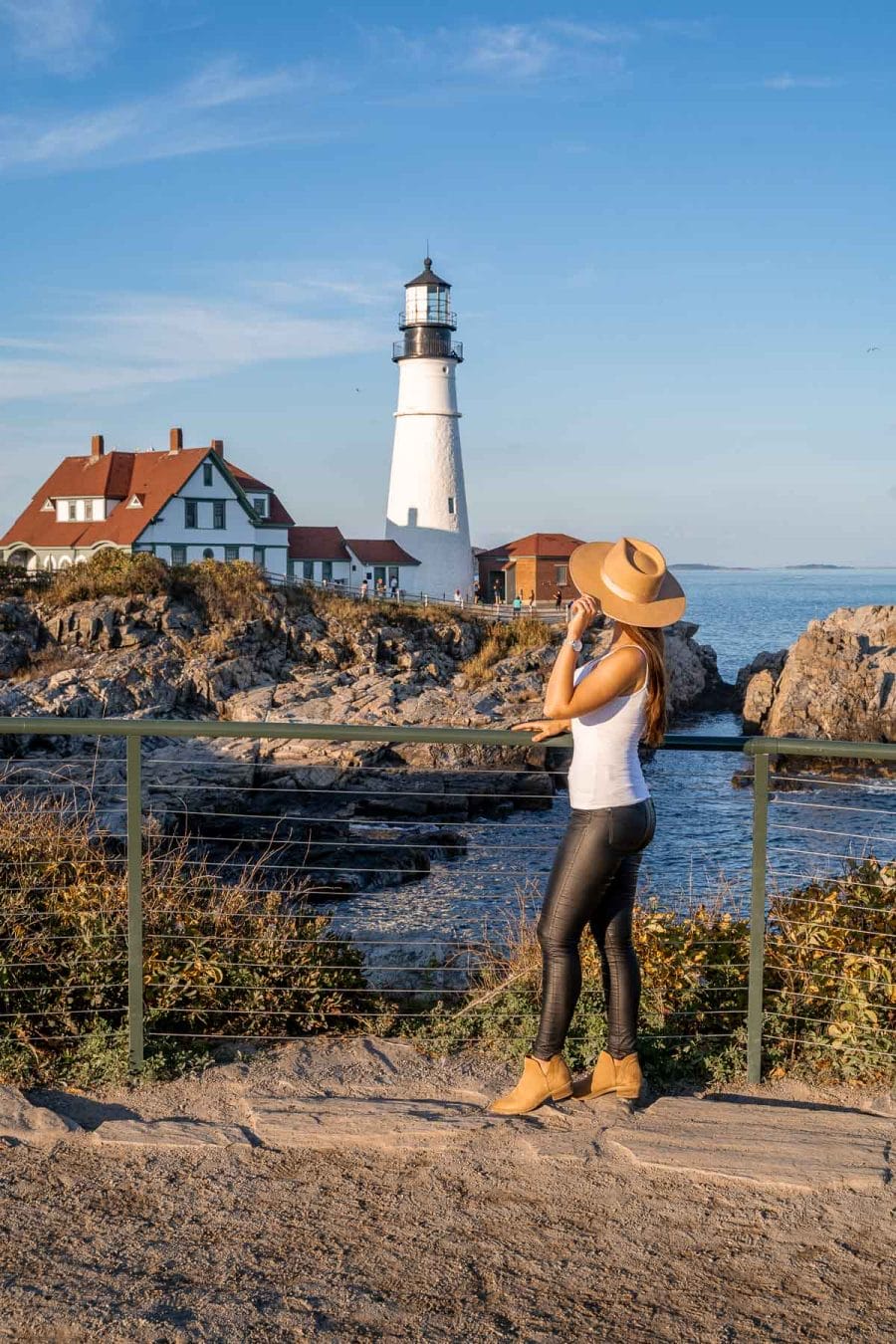 Girl in front of Portland Head Light, one of the best lighthouses in Portland