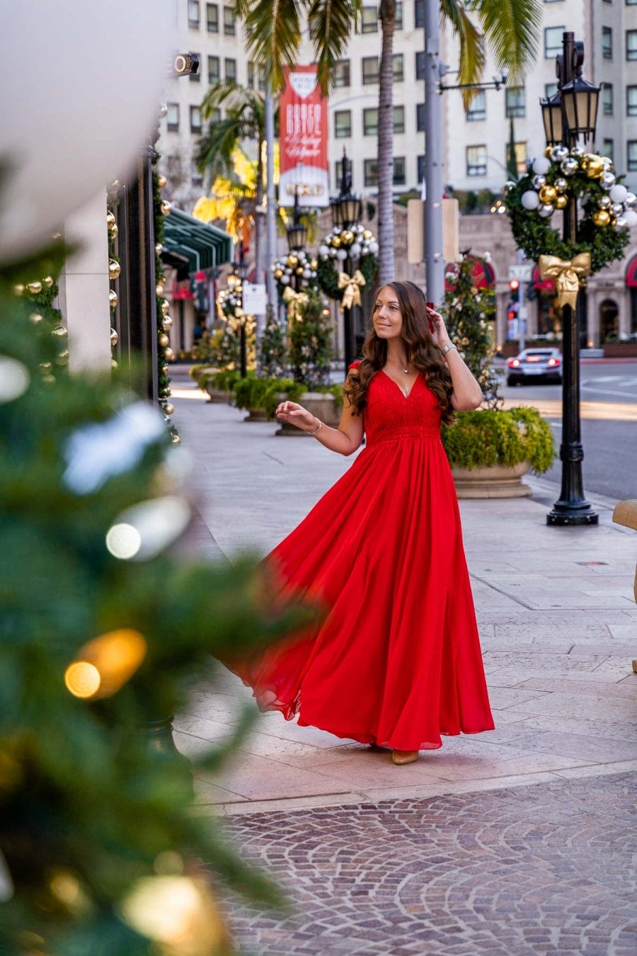 Girl in a red dress at Rodeo Drive at Christmas